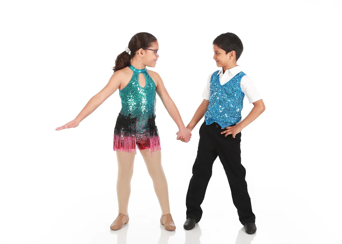 Two kids holding hands and dancing in a class